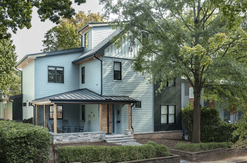 a large blue house with a metal roof