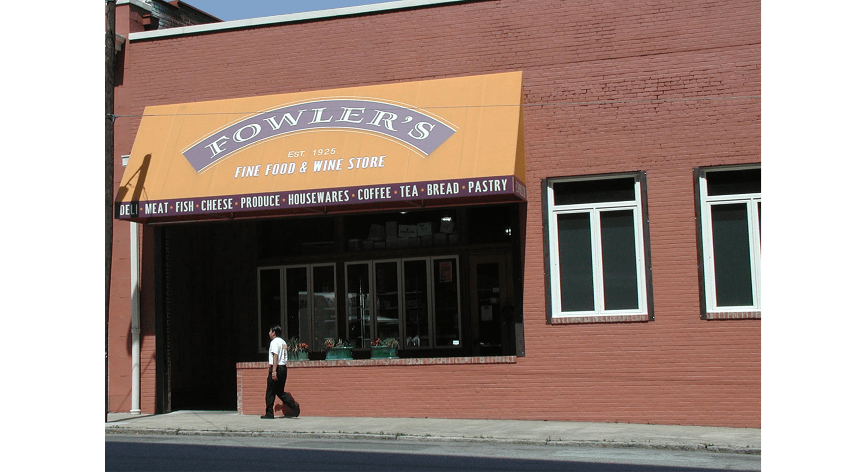 a man walking in front of a building