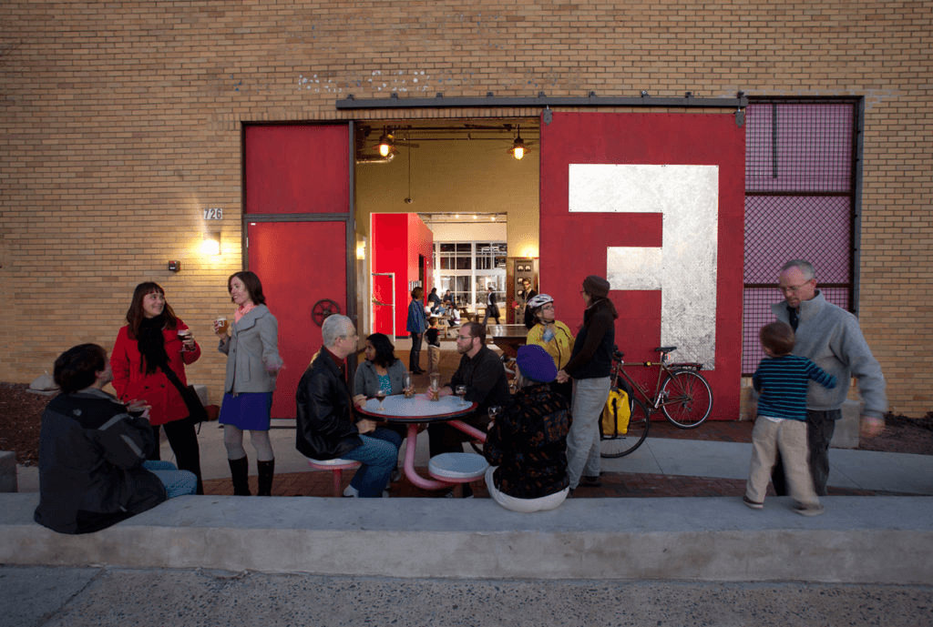 a group of people sitting at a table outside of a building