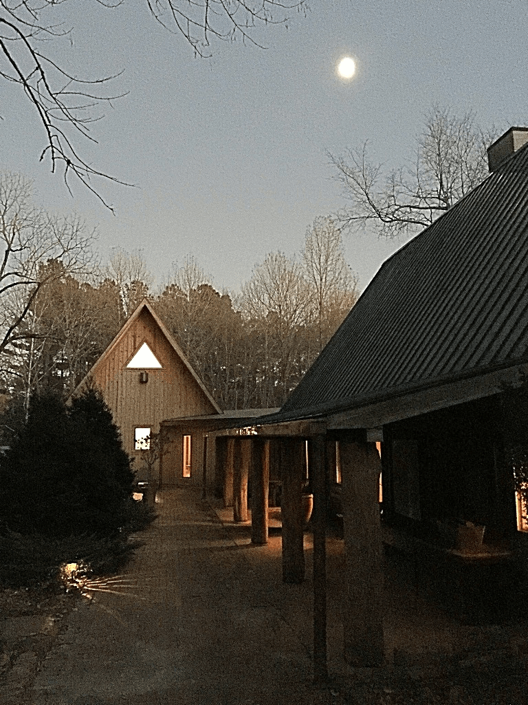 a house with a full moon in the background